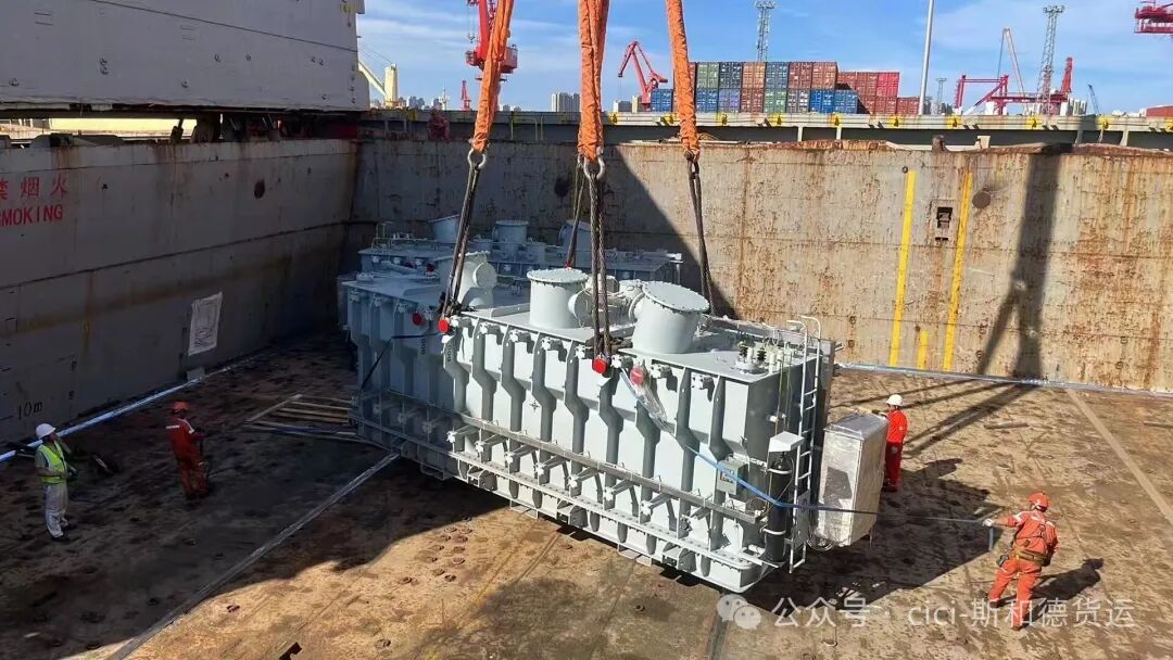 Deck crew applying ratchet lashings to secure the 128-ton transformer inside the vessel hold