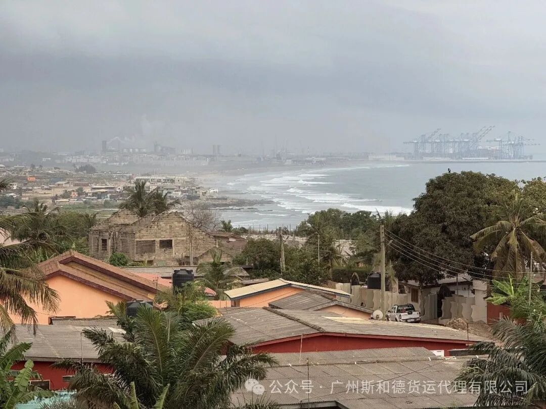 Tema port and coastline in Ghana seen from the hills, with gantry cranes along the harbour